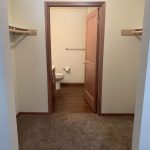 Town Square Residential Suites walk in closet looking into bathroom