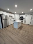 Rum River Residential Suites open kitchen with stainless appliances